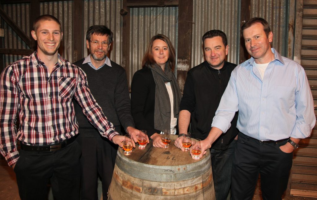 People holding whisky glasses